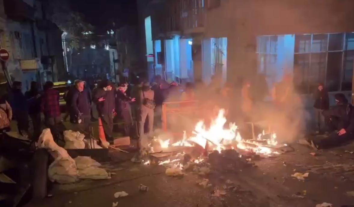 Protesters in Tbilisi light a fire and are not going to disperse